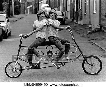 Twins on a curious bicycle, England, Great Britain View Large Photo Image Stock Image - Twins on a curious bicycle, England, Great Britain. Fotosearch