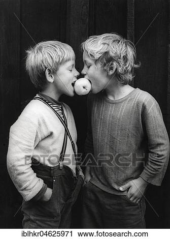 Two boys share an apple about 1970s, exact place unknown, Czech Republic, Europe View Large Photo Image Stock Image - Two boys share an apple about 1970s, exact place unknown, Czech Republic, Europe. Fotosearch