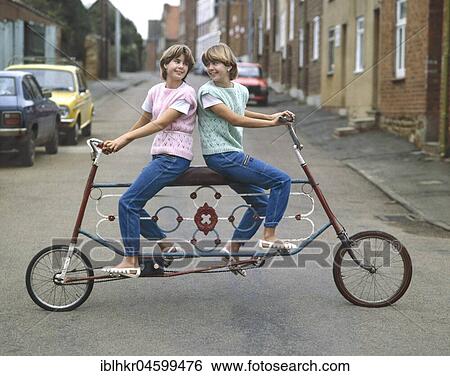 Two girls driving tandem, England, Great Britain View Large Photo Image Stock Photograph - Two girls driving tandem, England, Great Britain. Fotosearch