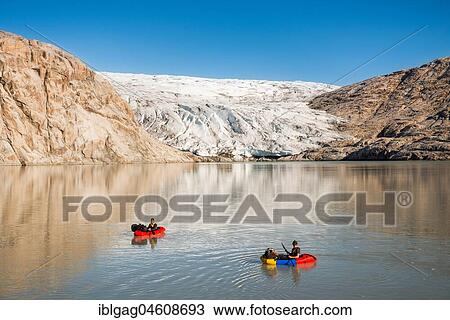 Two persons with pack rafts on fjord, behind glacier and rocks, blue sky, Greenland, North America View Large Photo Image Stock Image - Two persons with pack rafts on fjord, behind glacier and rocks, blue sky, Greenland, North America. Fotosearch