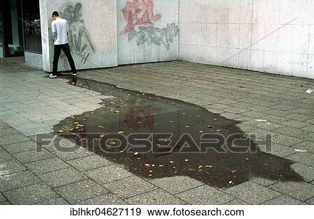 Stock Photo - Urine puddle behind Mann, Berlin, Germany, Europe. Fotosearch