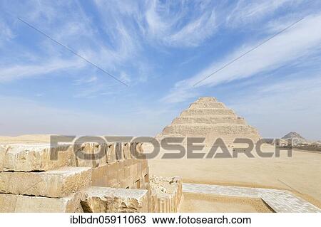 Stock Image - Wall engraved with images of cobra snakes next to stepped pyramid, Saqqara, Egypt, Africa. Fotosearch