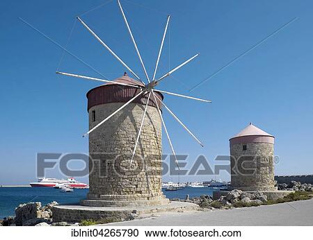 Stock Image - Windmills at Mandraki Harbour, Rhodes Town, Rhodes, Dodecanese, Greece, Europe. Fotosearch