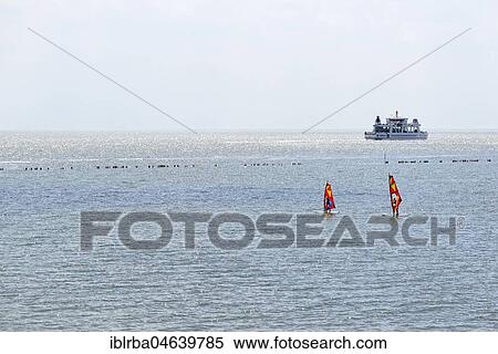 Stock Photography - Windsurfers in the Wadden Sea, car ferry to Norddeich, Norderney, East Frisian Islands, North Sea, Lower Saxony, Germany, Europe. Fotosearch