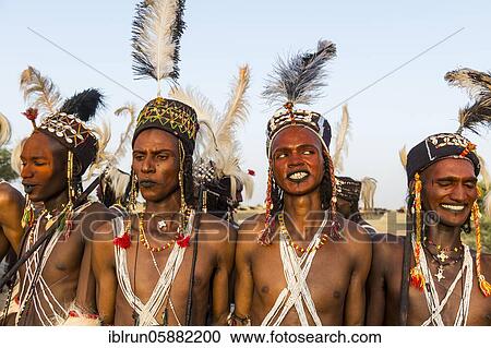 Stock Image - Wodaabe-Bororo men with faces painted at the annual Gerewol festival, courtship ritual competition among the Woodaabe Fula people, Niger, Africa. Fotosearch