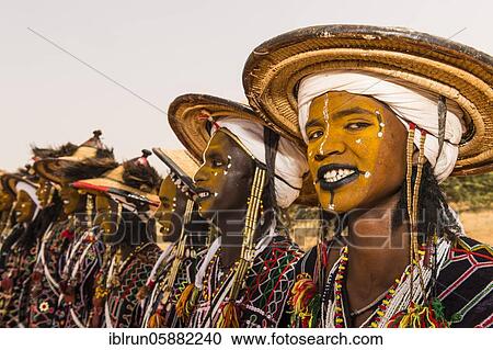 Stock Image - Wodaabe-Bororo men with faces painted at the annual Gerewol festival, courtship ritual competition among the Woodaabe Fula people, Niger, Africa. Fotosearch