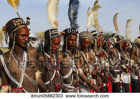 Stock Image - Wodaabe-Bororo men with faces painted at the annual Gerewol festival, courtship ritual competition among the Woodaabe Fula people, Niger, Africa. Fotosearch
