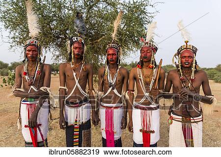 Stock Photo - Wodaabe-Bororo men with faces painted at the annual Gerewol festival, courtship ritual competition among the Woodaabe Fula people, Niger, Africa. Fotosearch