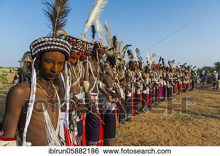 Stock Photograph - Wodaabe-Bororo men with faces painted at the annual Gerewol festival, courtship ritual competition among the Woodaabe Fula people, Niger, Africa. Fotosearch