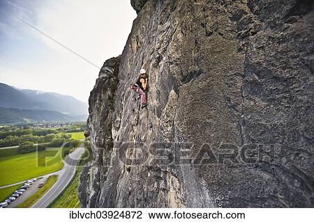 Stock Image - Woman climbing, lead climbing, on a rock face, Martinswand, Zirl, Tyrol, Austria, Europe. Fotosearch