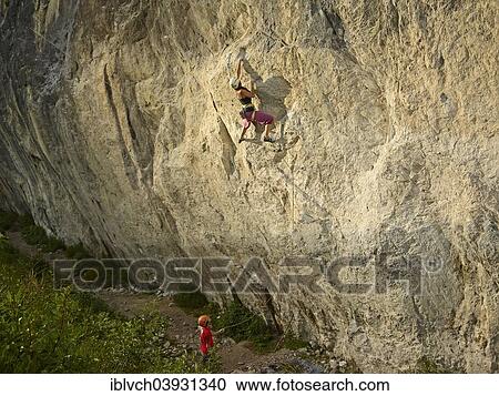 Stock Image - Woman climbing, lead climbing, on a rock face, Martinswand, Zirl, Tyrol, Austria, Europe. Fotosearch