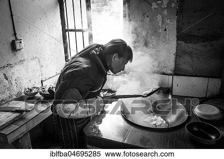 Woman cooking in a farmhouse in Ping'An in Zhangjiajie National Forest Park, China, Asia View Large Photo Image Stock Photography - Woman cooking in a farmhouse in Ping'An in Zhangjiajie National Forest Park, China, Asia. Fotosearch