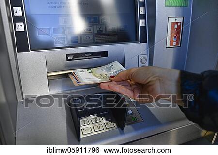 Woman draws 100 EURO cash at the cash machine of a savings bank, Waiblingen, Baden-Württemberg, Germany, Europe View Large Photo Image Stock Photograph - Woman draws 100 EURO cash at the cash machine of a savings bank, Waiblingen, Baden-Württemberg, Germany, Europe. Fotosearch