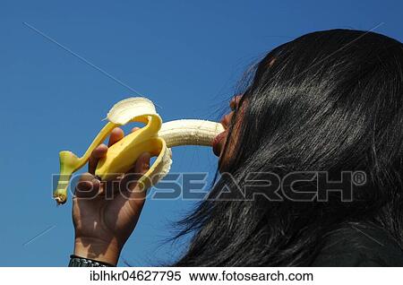 Stock Photography - Woman eating banana, Germany, Europe. Fotosearch