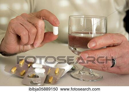 Woman holding medication pill, France, Europe View Large Photo Image Stock Image - Woman holding medication pill, France, Europe. Fotosearch