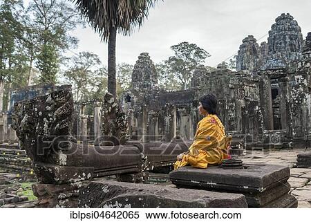 Woman meditates at Bayon Temple, Angkor Thom, Cambodia, Asia View Large Photo Image Stock Photography - Woman meditates at Bayon Temple, Angkor Thom, Cambodia, Asia. Fotosearch