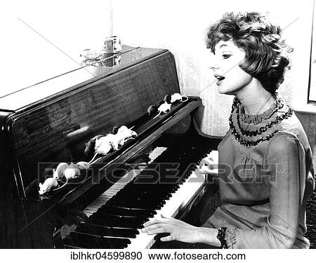 Woman playing piano for white mice, England, Great Britain View Large Photo Image Stock Image - Woman playing piano for white mice, England, Great Britain. Fotosearch