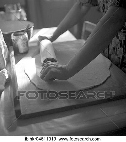 Stock Photo - Woman rolls dough flat, housewife bakes, ca. 1950, Freiburg, Germany, Europe. Fotosearch