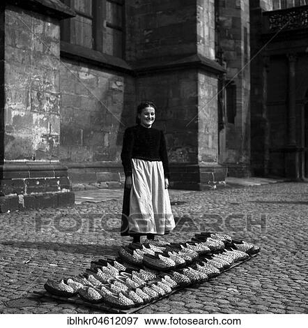 Woman sells shoes, Freiburger Münstermarkt, approx. 1945 to 1955, Freiburg, Germany, Europe View Large Photo Image Stock Photo - Woman sells shoes, Freiburger Münstermarkt, approx. 1945 to 1955, Freiburg, Germany, Europe. Fotosearch