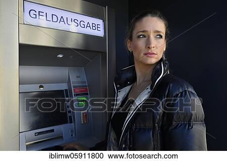 Woman standing in front of an ATM at a savings bank, looking around, Waiblingen, Baden-Württemberg, Germany, Europe View Large Photo Image Stock Image - Woman standing in front of an ATM at a savings bank, looking around, Waiblingen, Baden-Württemberg, Germany, Europe. Fotosearch