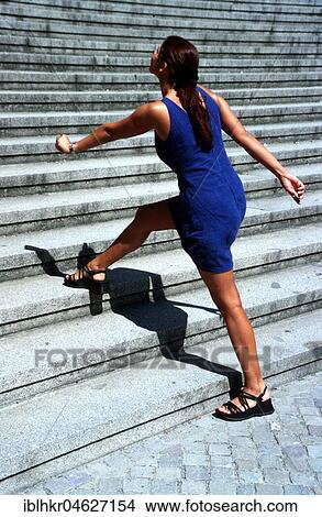 Woman takes three levels at once, Berlin, Germany, Europe View Large Photo Image Picture - Woman takes three levels at once, Berlin, Germany, Europe. Fotosearch