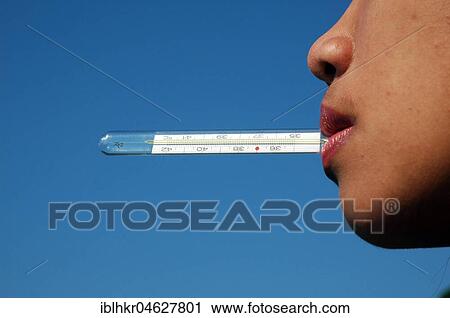 Woman with clinical thermometer in her mouth, Germany, Europe View Large Photo Image Stock Image - Woman with clinical thermometer in her mouth, Germany, Europe. Fotosearch