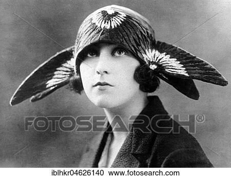 Stock Image - Woman with funny hat, ca. 1920, exact place unknown, Cuba, Caribbean, Central America. Fotosearch