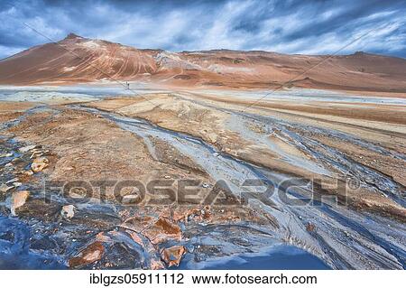 Woman with photo tripod standing in the Hverir thermal field, hot blue spring water flowing over red plain, in the back mountain Námafjall in the high temperature area Hverarönd, Skútustaðir, Norðurland eystra, Iceland, Europe View Large Photo Image Stock Image - Woman with photo tripod standing in the Hverir thermal field, hot blue spring water flowing over red plain, in the back mountain Námafjall in the high temperature area Hverarönd, Skútustaðir, Norðurland eystra, Iceland, Europe. Fotosearch