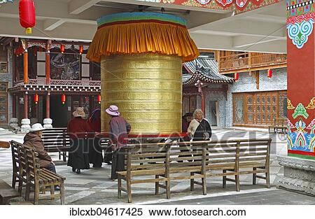 Women turn a prayer wheel, Kangding, autonomous district Garzê of Tibetans, Sichuan, China, Asia View Large Photo Image Stock Photography - Women turn a prayer wheel, Kangding, autonomous district Garzê of Tibetans, Sichuan, China, Asia. Fotosearch