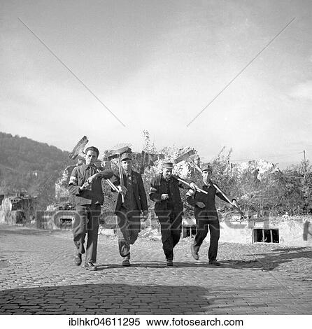 Worker with field tools on his shoulder, evening off for field workers, ca. 1950, near Freiburg, Germany, Europe View Large Photo Image Stock Photography - Worker with field tools on his shoulder, evening off for field workers, ca. 1950, near Freiburg, Germany, Europe. Fotosearch