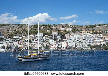 Stock Image - Yacht in front of skyscrapers, Saranda, Ionian Sea, Albania, Europe. Fotosearch