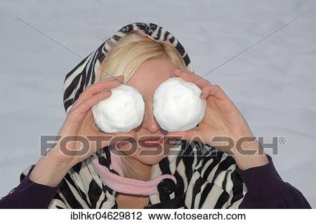 Young blonde woman with two snowballs in front of her eyes, Germany, Europe View Large Photo Image Stock Image - Young blonde woman with two snowballs in front of her eyes, Germany, Europe. Fotosearch