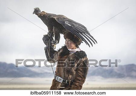 Young eagle hunter with her female eagle, Olgii, Mongolia, Asia View Large Photo Image Stock Photo - Young eagle hunter with her female eagle, Olgii, Mongolia, Asia. Fotosearch