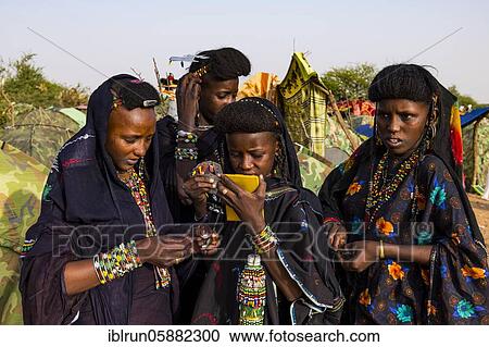 Stock Image - Young girls at the Gerewol festival, courtship ritual competition among the Woodaabe Fula people, Niger, Africa. Fotosearch