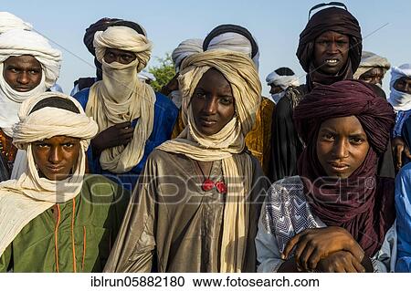 Stock Image - Young men arriving for the Gerewol festival, courtship ritual competition among the Woodaabe Fula people, Niger, Africa. Fotosearch