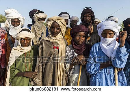 Stock Image - Young men arriving for the Gerewol festival, courtship ritual competition among the Woodaabe Fula people, Niger, Africa. Fotosearch