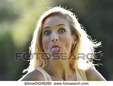 Stock Photography - Young woman, sassy, tongue sticking out, facial expression. Fotosearch