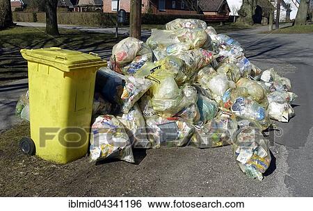 Accumulation of garbage bags, recycling sacks, yellow bags, ready to be picked, Kiel-Oppendorf, Schleswig-Holstein, Germany, Europe View Large Photo Image Stock Photograph - Accumulation of garbage bags, recycling sacks, yellow bags, ready to be picked, Kiel-Oppendorf, Schleswig-Holstein, Germany, Europe. Fotosearch
