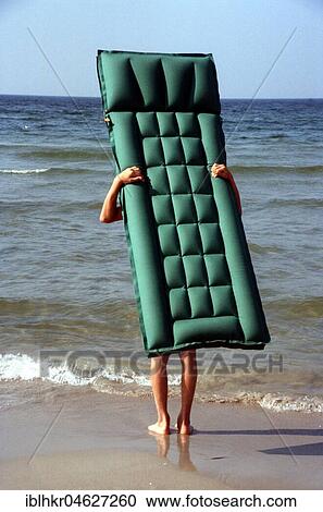 Air mattress with legs on the beach View Large Photo Image Stock Image - Air mattress with legs on the beach. Fotosearch