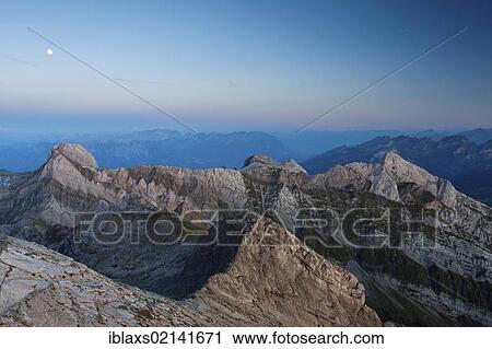 Stock Image - Alpstein Mountains with the summit of Altmann Mountain and the full moon rising, Appenzell Outer Rhodes, Switzerland, Europe, PublicGround, Europe. Fotosearch