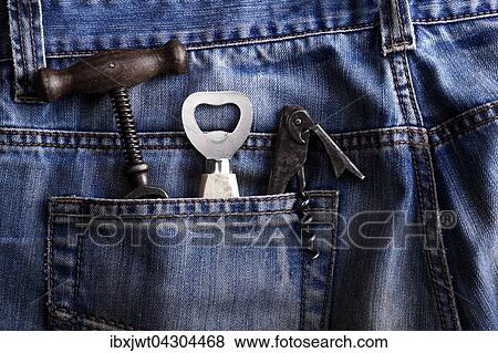 Alter Korkenzieher, Flaschenoffner und Kellnermesser in der Hosentasche einer Jeans View Large Photo Image Stock Photo - Alter Korkenzieher, Flaschenoffner und Kellnermesser in der Hosentasche einer Jeans. Fotosearch