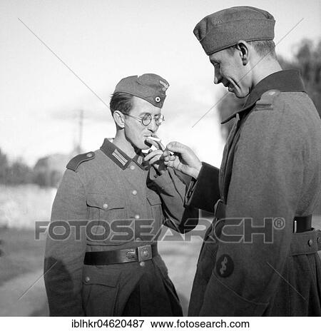 Approx. 1939, 1941, training Wehrmacht, soldier hands someone else his cigarette to light, Ulm, Germany, Europe View Large Photo Image Stock Photo - Approx. 1939, 1941, training Wehrmacht, soldier hands someone else his cigarette to light, Ulm, Germany, Europe. Fotosearch