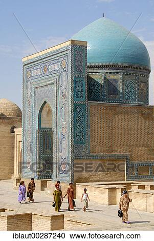 Stock Image - Believers at blue decorated mausoleum necropolis Shah-i-Zinda Samarkand Uzbekistan. Fotosearch