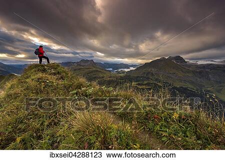 Bergsteiger blickt auf Gipfel des Widderstein, Allgauer Alpen, Wolkenstimmung am Morgen, Warth, Vorarlberg, Osterreich, Europa View Large Photo Image Stock Image - Bergsteiger blickt auf Gipfel des Widderstein, Allgauer Alpen, Wolkenstimmung am Morgen, Warth, Vorarlberg, Osterreich, Europa. Fotosearch