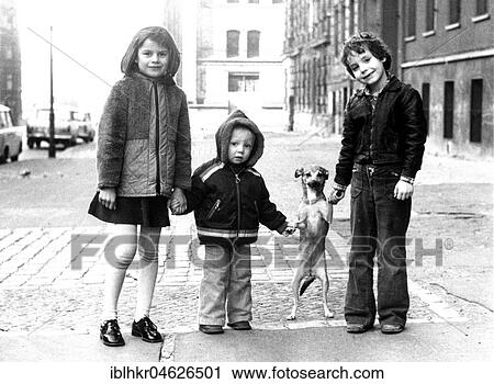 Stock Image - Children with small dog, ca. 1980s, East Berlin, GDR, Germany, Europe. Fotosearch
