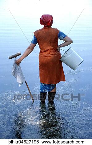 Stock Photograph - Cleaning lady at sea, Berlin, Germany, Europe. Fotosearch