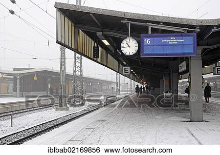 Stock Photograph - Departure board, railway tracks, snow, main station, Dortmund, Ruhr Area, North Rhine-Westphalia, Germany, Europe. Fotosearch