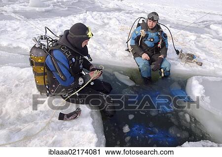 Stock Image - Divers, preparing for subglacial diving, ice diving, in the frozen Black Sea, a rare phenomenon, last time it occured in 1977, Odessa, Ukraine, Eastern Europe, Europe. Fotosearch