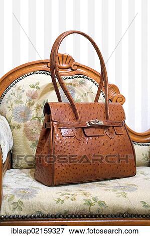 Elegant ostrich leather handbag on an antique sofa View Large Photo Image Stock Photo - Elegant ostrich leather handbag on an antique sofa. Fotosearch