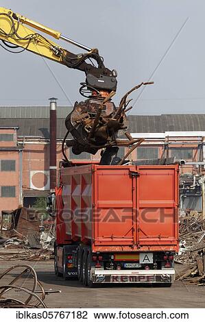Excavator loads metal scrap onto truck, Demolition of an industrial hall, Duisburg, North Rhine-Westphalia, Germany, Europe View Large Photo Image Stock Image - Excavator loads metal scrap onto truck, Demolition of an industrial hall, Duisburg, North Rhine-Westphalia, Germany, Europe. Fotosearch